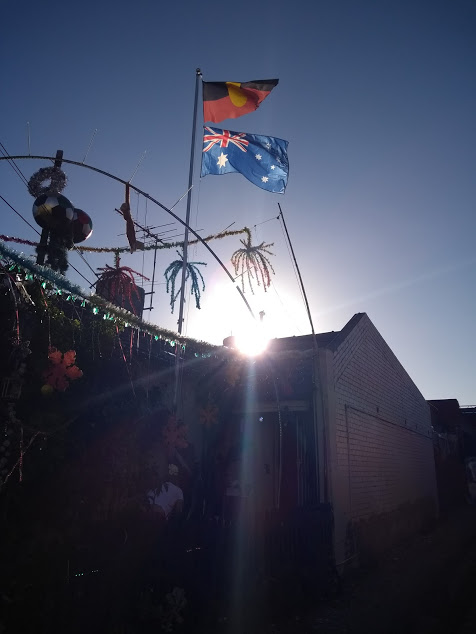 Primavera in Australia: sole dietro a bandiera australiana e aborigena
